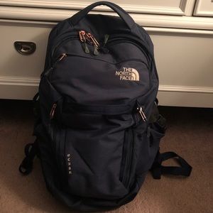 navy blue and rose gold north face backpack